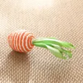 Handmade woven carrot ornament detail view, rustic straw handicraft for home decor. - Green Silk Carrot