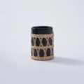 Detailed view of black glass bottle featuring handmade natural rattan woven protective sleeve cover. - Style 9