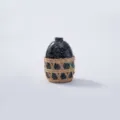 Close-up detail of the black speckled bottle with handmade woven straw protective net cover. - Style 4
