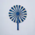 Handmade woven fan detail, blue and white straw pattern, natural craftsmanship texture. - Style 18