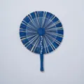 Detailed close-up of handmade blue straw fan, showing intricate woven texture and natural craft. - Style 23