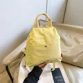 Stylish casual yellow backpack for women, versatile daily commuter school bag with handle. - Yellow