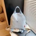 Casual light blue commuter backpack, stylish candy color design for daily outdoor travel use. - Blue