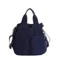 Navy blue nylon tote bag for women, casual shoulder bag with dual handles and front pockets. - Dark Blue