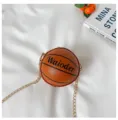 Basketball shaped crossbody bag detail view with chain strap and stylish design elements. - Brown