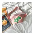 Detail view of pink kids waist pack featuring cute green dinosaur embroidery and strap. - S / Pink