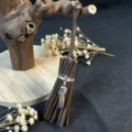 Close-up view of handmade witch crystal broom ornament, rustic twig detail and shimmering charm. - 10*3.5CM / Multi-Color