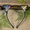 Detailed shot of handmade black cat ear headband with crystal clusters and wire wrapping. - Blue Red + Yellow