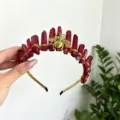 Detailed view of red crystal crown headband with gold wire wrap and bee charm for festival styling. - Bright Red With Gold Bee
