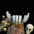 Detailed view of gothic crystal headband with natural quartz columns and vintage bird skull charms. - Rose Quartz + Antique Bronze Crow Skull