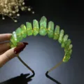 Detailed view of a green crystal crown headband with gold wire wrap for women photography. - Green