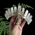 Detail view of the crystal crown headband featuring sun goddess motif and raw crystal pillars. - Coated Rose Quartz