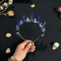Close-up detail of gothic crystal crown headband with natural blue stones and metal skull accents. - Lapis Lazuli And Silver Crow Head