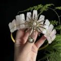 Close-up detail of the natural raw pink crystal crown with golden sun metal pendant and pearl. - Rose Quartz