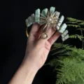 Detailed view of handmade crystal crown headband with sun goddess charm for photography. - Amazonite