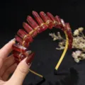 Detailed view of handmade red quartz crystal crown headband with gold wire wrapping design. - Red