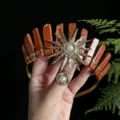 Detailed view of the natural red crystal crown with a gold sun goddess charm and pearl accents. - Red Jasper