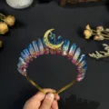 Close-up detail of the crystal crown headband featuring a golden star and moon charm wire. - Blue Red Gold Moon and Gold Star