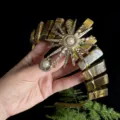Detailed view of the tiger eye crystal crown headband with gold sun goddess pearl charm. - Tiger's Eye