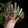 Detail view of handmade crystal crown headband with sun goddess charm and natural stone pillars. - Unakite