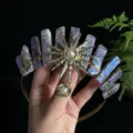 Close-up detail showing the natural crystal crown headband with a radiant sun goddess pendant. - Coated Amethyst