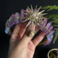 Detail view of crystal crown headband with gold sunburst charm and aura quartz clusters. - Pink Blue Gold Sun