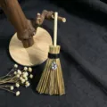 Detailed view of miniature wicca witch broom hanging ornament with crystal pendant and natural grass. - Clear Teardrop Crystal Style / Approx. 15cm