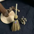 Closeup of mini witch broom hanging ornament with crystal pendant and natural straw material detail. - Iridescent Crystal Style / Approx. 15cm
