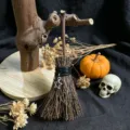 Detailed view of a miniature witch broom Halloween decoration with star charm and rustic display. - Star Pendant Style / 13*4cm