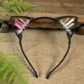 Close-up detail of handmade crystal cat ears headband with pink and clear quartz stones. - Pink + White