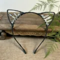 Detailed view of handmade black crystal cat ear headband wire wrapped natural quartz stones. - Tawny + White