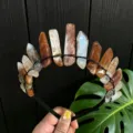 Detailed view of raw crystal tiara headband, handmade with irregular stones for festival photo. - Red Brown