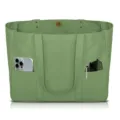 Green canvas tote bag detail showing multiple outer pockets and durable dual handles. - Green
