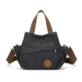 Borsa a tracolla in tela vintage lavata con tasca frontale con zip per il lavoro. - Nero