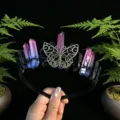 Close-up detail view of the handmade crystal crown headband featuring metallic butterfly motif. - Red and Blue and Antique Bronze Butterfly