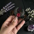 Detail view of a gothic natural crystal crescent moon flower headband for women hair accessory. - Dark Purple and Black and Black Wire and Antique Bronze Hollow Moon Flower