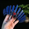 Detailed shot of a gorgeous handmade lapis lazuli crystal crown headband with a red rose charm. - Lapis Lazuli + Black Moon + Flower