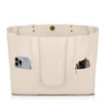 Detail shot of canvas tote bag with front pocket holding phone and sunglasses, close up view. - Off White