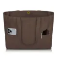 Close-up detail of the brown canvas tote bag showing exterior storage pockets and magnetic snap. - Dark Brown