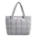 Close-up of the grey quilted puffer tote bag highlighting its padded grid pattern and front pocket. - 17.7 x 5.9 x 12.6 Inches / Silver
