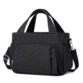 Black quilted lunch bag detail showing durable dual handles, front pocket, and metal hardware. - 29.5 x 6.5 x 23CM / Black
