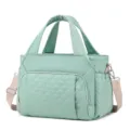Quilted green lunch bag detail view, thermal insulated handbag with sturdy handles and adjustable strap. - 29.5 x 6.5 x 23CM / Light Green