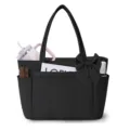 Detail view of black nylon tote bag featuring front utility pockets and elegant side bow accent. - Black