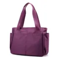 Detail view of purple nylon travel tote bag, lightweight casual shoulder handbag for women. - Purple
