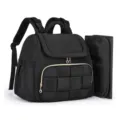 Close-up detail of black quilted diaper backpack featuring changing pad and woven pocket. - 14.9 x 5.9 x 12 Inches / Black