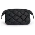 Close-up detail of the black quilted puffy cosmetic bag showcasing soft fabric and zipper. - Black
