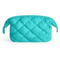 Detail view of the turquoise quilted puffy cosmetic bag, featuring soft fabric and smooth zipper. - Emerald
