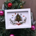 Miniature white picture frame detail with Christmas tree illustration for dollhouse decor. - Christmas Tree