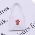 Miniature dollhouse canvas tote bag with cute red mushroom print for tiny scene display. - White