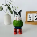 Detailed close-up shot of hand-carved wooden French bulldog figurine with painted clothes. - French Bulldog Ornament